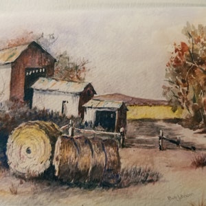 Puede incluir: Pintura acuarela de una escena rural con dos graneros, pacas de heno y árboles en el fondo. La pintura está firmada "Ruy Johnson".