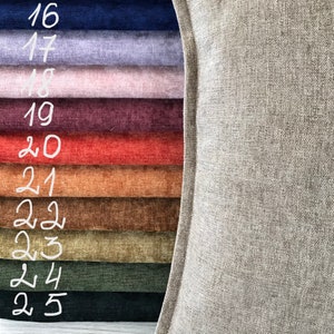 May include: A close-up of a variety of fabric swatches in different colors and textures, including navy blue, lavender, pink, burgundy, red, orange, brown, green, and black. The swatches are numbered 16 through 25.