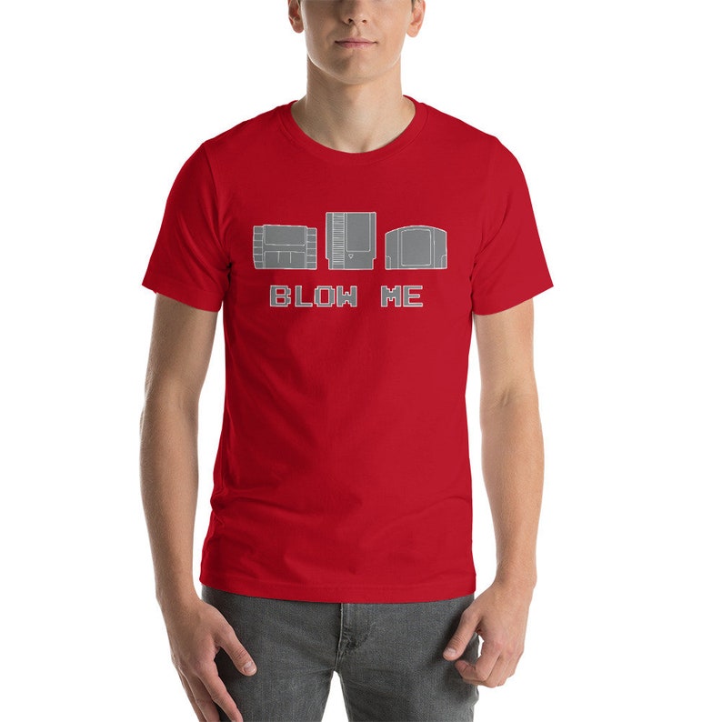 May include: Red t-shirt with a graphic of three video game cartridges and the text "BLOW ME".