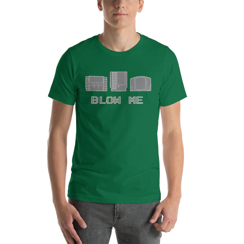 May include: A green t-shirt with a white graphic of three video game cartridges and the text "BLOW ME".