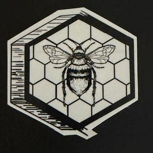 Black and white bee in honeycomb sticker