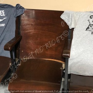 May include: Two t-shirts featuring a Tennessee state outline design. The shirts are grey and dark blue. The design includes a guitar, a moon, and the words "Tennessee" and "Home Sweet Home".
