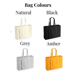 May include: Four tote bags in different colors: natural, black, grey, and amber. The bags are made of canvas and have a simple design with two handles.