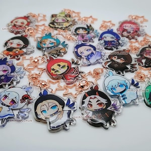 May include: A collection of acrylic keychains featuring various anime-style characters with colorful outfits and hair. Each charm is attached to a rose gold star-shaped clasp. The text SHIROUU-KUN is printed in small white letters on each individual charm.