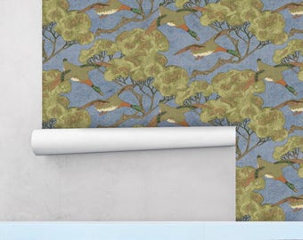May include: A roll of wallpaper with a repeating pattern of green trees and brown birds on a blue background.