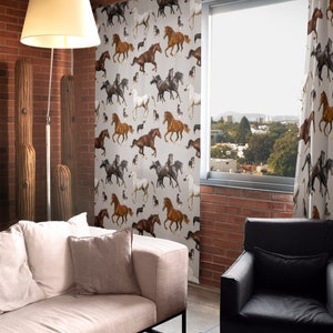 May include: Curtains with a repeating pattern of running horses in various colors, including brown, black, and white, against a light gray background. The curtains are hanging in front of a window, with a view of a cityscape.