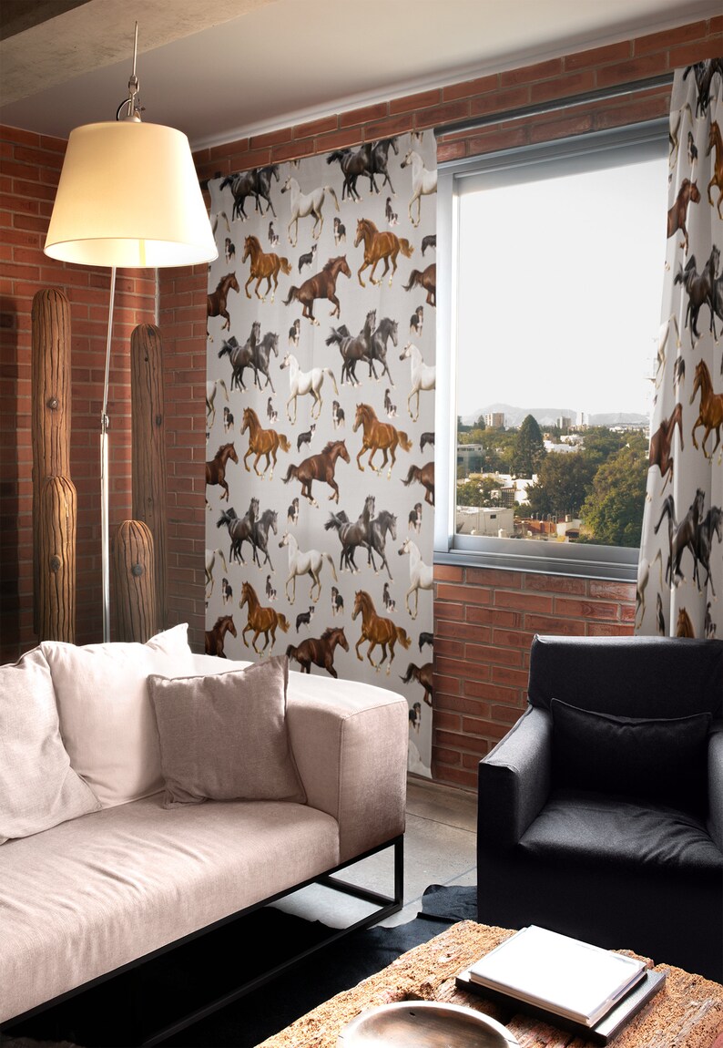May include: Curtains with a repeating pattern of running horses in various colors, including brown, black, and white, against a light gray background. The curtains are hanging in front of a window, with a view of a cityscape.