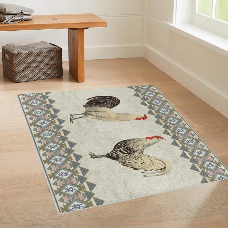 May include: A white and gray rug with a geometric pattern border and two roosters in the center. The roosters are facing opposite directions and have red combs and wattles.