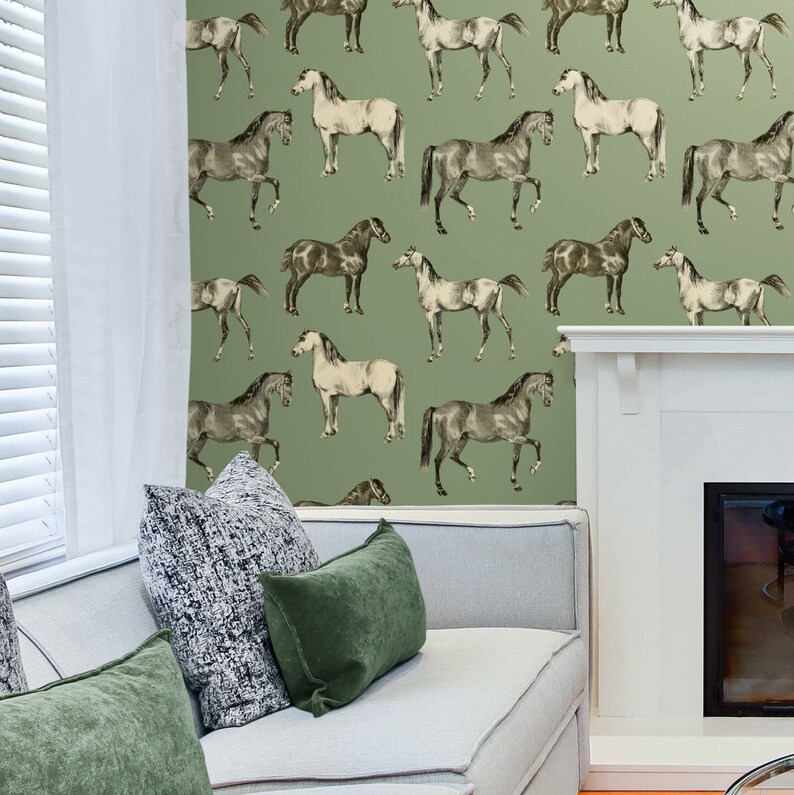 May include: A green wallpaper with a repeating pattern of black and white horses. The wallpaper is in a living room setting with a white couch and green pillows.
