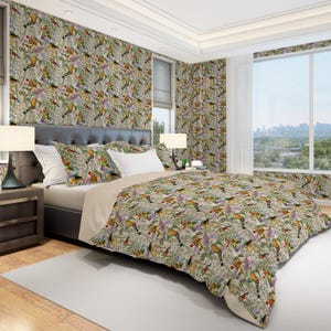 May include: A bedroom set featuring a bed with a patterned comforter, pillows, and matching wallpaper. The pattern includes colorful birds, flowers, and foliage on a light background. The room has a large window with a city view.
