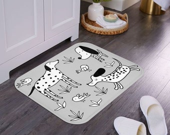 May include: A gray and white doormat with a black and white illustration of four dogs and birds. The dogs are all different breeds and are in various poses. The birds are flying and perched on branches. The doormat has a gray background with white leaves and branches.