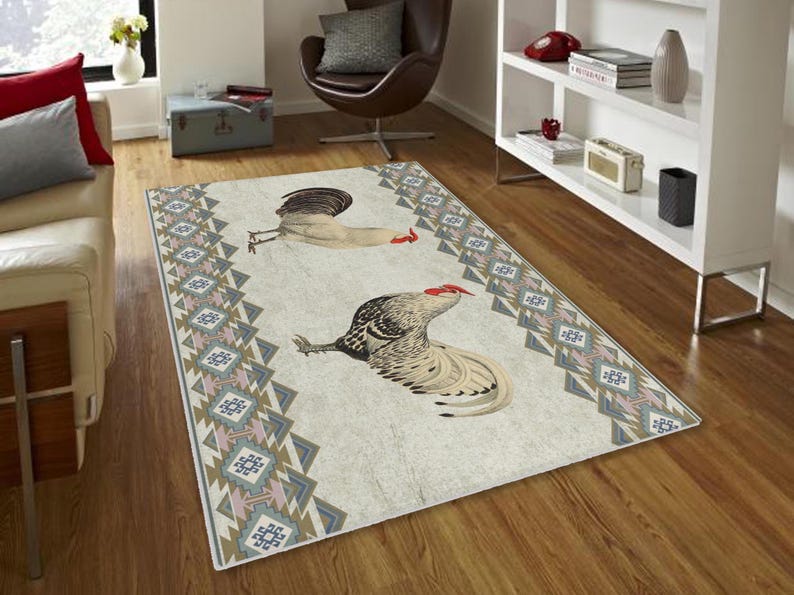 May include: A white and gray area rug with a geometric pattern in shades of pink, blue, and brown. The rug features a stylized illustration of two roosters with red combs.
