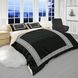 May include: Black and white bedding set with a Greek key border design. The duvet cover is black with a white Greek key border. The pillowcases are white with a black Greek key border.
