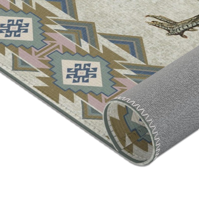 May include: Close-up of the edge of a rug with a geometric pattern in shades of brown, blue, green, and pink. The rug has a gray backing with white stitching.