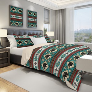 May include: A teal, red, and brown patterned duvet cover with black bear silhouettes. The duvet cover is on a bed with two matching pillowcases.