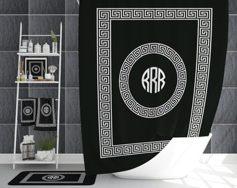 May include: Black and white shower curtain with a Greek key border and a monogram in a circle in the center. The monogram is "RRB".