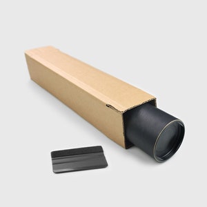 May include: A brown cardboard tube with a black roll inside. A black plastic squeegee with a gray foam edge is next to the tube.