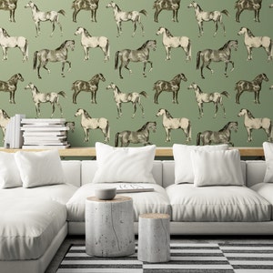 May include: A green wallpaper with a repeating pattern of black and white horses. The wallpaper is in a living room setting with a white couch, two wooden end tables, and a black and white striped rug.