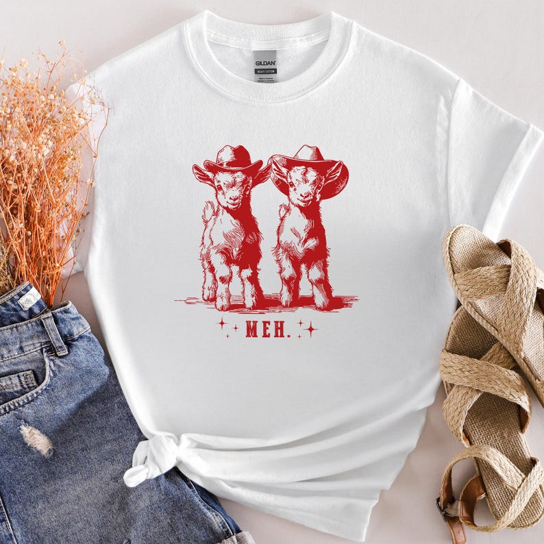 a white shirt with a red print of two dogs wearing cowboy hats