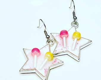 Gorgeous Polymer Clay Pink Glitter Stars encased in a Stainless Steel Star Bezel, finished with UV Resin and Tiny Lollipops on the front.