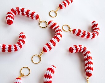 May include: Six red and white striped crocheted candy cane keychains with gold key rings.