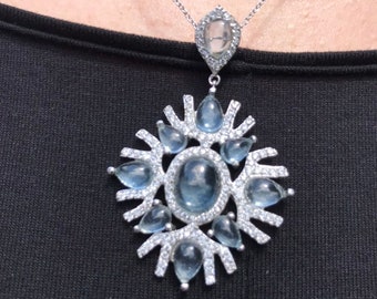 Sterling silver pendant with blue topaz and white CZ