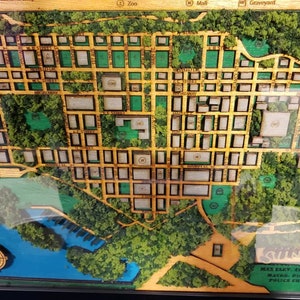 May include: A wooden model of a town called Sunnydale, with a green and brown color scheme. The model includes a zoo, a mall, and a graveyard. The text on the model reads "Sunnydale, Est. 1908, Max. Elev. 49', Area: 47 sq. mi., Mayor: Richard Wilkins III, Police Chief: Jim and Rhonda".