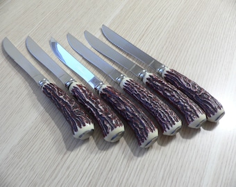 Vintage Debonair stainless steel 6 steak knives faux antler handles hollow ground.Japan steak knives with serrated blades bakelite handles.