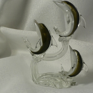Vintage Murano art glass trio of dolphins on a wave nautical sculpture. Sommerso style clear white and olive green dolphins gliding on waves