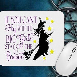May include: White rectangular mousepad with the text "IF YOU CAN'T Fly WITH THE BIG Girls STAY OFF THE Broom" in purple. A black silhouette of a witch on a broom is featured, along with yellow stars. A white computer mouse is on the right.