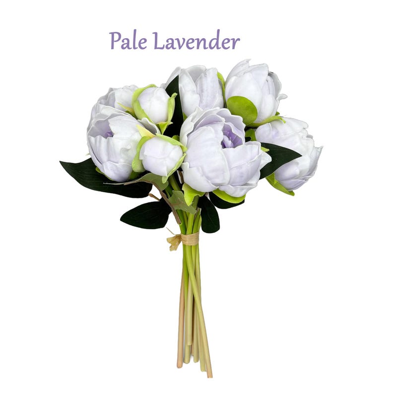 May include: A bouquet of pale lavender artificial peonies with green leaves and stems. The bouquet is tied with a brown ribbon and the text "Pale Lavender" is written above the bouquet.