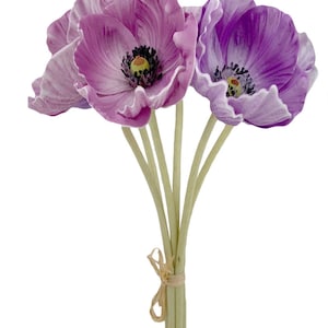 May include: A bouquet of five artificial purple poppies with green stems tied together with a brown ribbon.