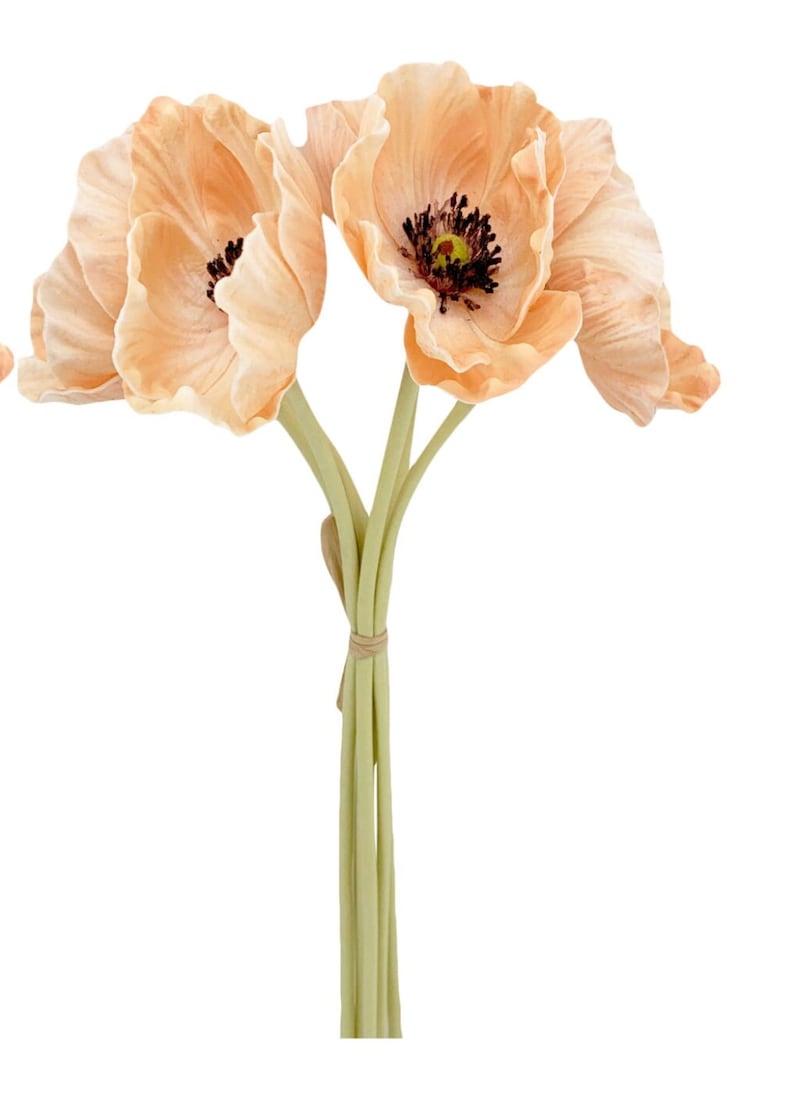 May include: A bouquet of three peach-colored artificial poppy flowers with brown centers. The stems are green and tied together with a brown ribbon.