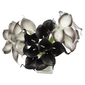 May include: A bouquet of artificial calla lilies in black and white. The flowers are arranged in a vase.