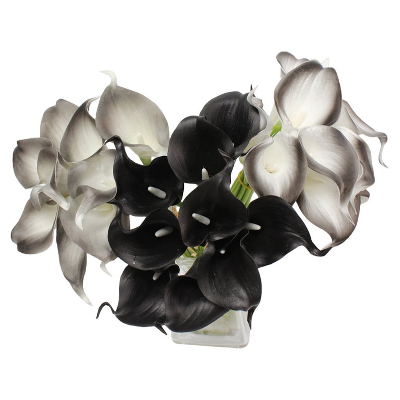 May include: A bouquet of artificial calla lilies in black and white. The flowers are arranged in a vase.