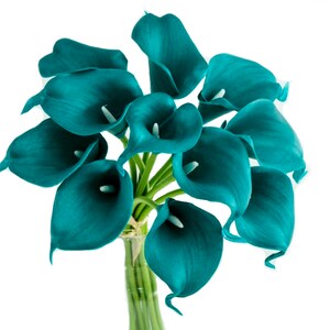 May include: A bouquet of teal calla lilies with smooth, trumpet-shaped petals and prominent white spadices. The flowers are arranged in a cluster with green stems gathered together at the base, creating a vibrant and uniform floral display.