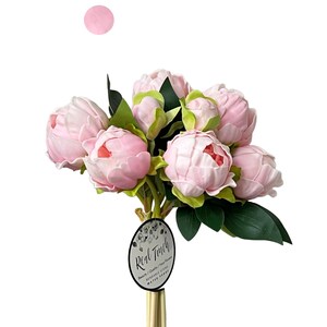 May include: A bouquet of pink artificial peonies with green leaves. The bouquet is arranged in a gold vase and has a tag that reads "Real Touch Beauty / Quality / Real Flowers".