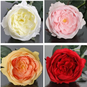 May include: Four artificial roses in different colors: white, pink, peach, and red. The roses are all in full bloom and have a realistic appearance.