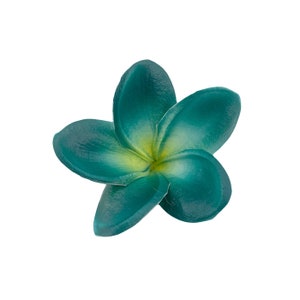 May include: A five-petaled plumeria flower with a smooth, matte texture. The petals transition from a deep teal color at the outer edges to a soft, pale yellow hue at the center, where the petals meet in a star-shaped arrangement.