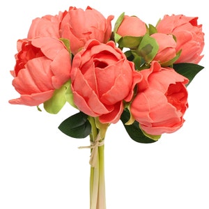 May include: A bouquet of 7 coral pink artificial peonies with green leaves and stems tied together with twine.