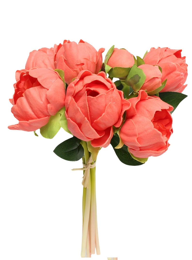 May include: A bouquet of 7 coral pink artificial peonies with green leaves and stems tied together with twine.