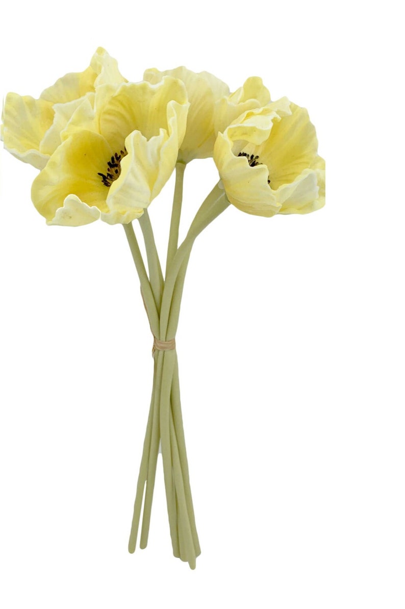 May include: A bouquet of four yellow silk poppy flowers with green stems tied together with a brown band.