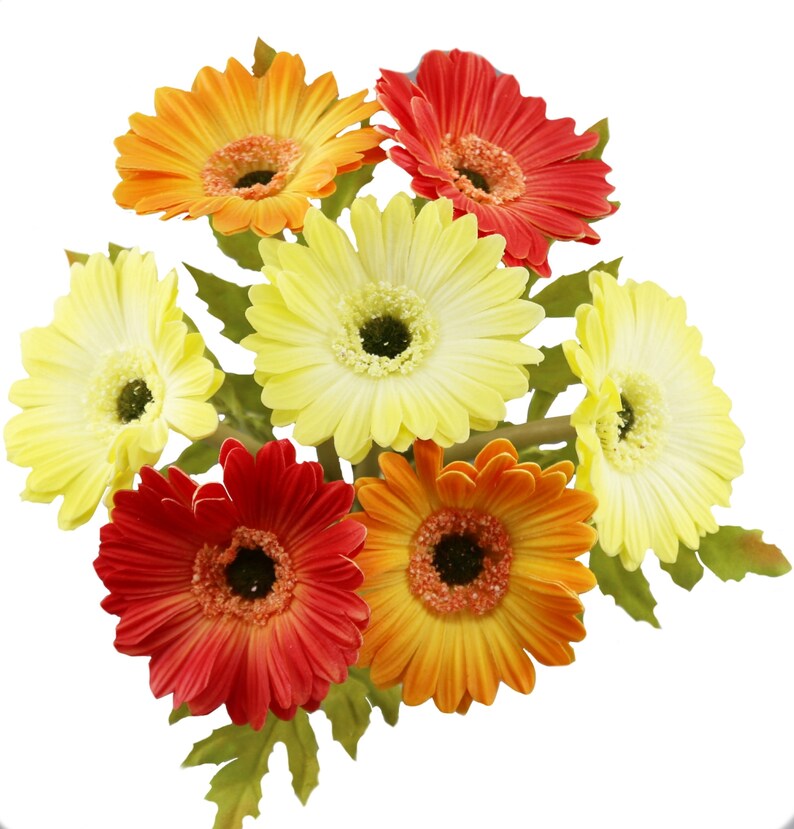 May include: A bouquet of artificial gerbera daisies in shades of yellow, orange, and red. The flowers have a realistic appearance and are arranged in a cluster.