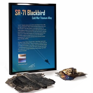 May include: Framed display featuring SR-71 Blackbird Cold War Titanium Alloy text and a piece of the aircraft. The display includes text about the aircraft's history and a fragment of the titanium alloy.
