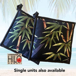 May include: Two black pot holders with a green bamboo leaf pattern. The pot holders are handmade in Hilo, Hawaii.