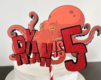 May include: Red and black cake topper with an octopus and the text "Ryan is 5".