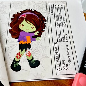 May include: A Halloween-themed nutrition facts label with a cartoon illustration of a zombie girl. The label lists the percentage of daily value for spooks, candy, laughter, bats, fun, and ghosts. The serving size is one giant pumpkin.