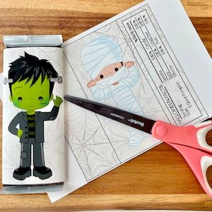 May include: A printable Halloween candy bar wrapper featuring a green Frankenstein monster with black hair and a black and grey suit. The wrapper has a spiderweb pattern. The text on the wrapper reads "HALLOWEEN FACTS" and includes a list of facts about Halloween, such as "100% Candy", "100% Laughter", and "100% Fun".