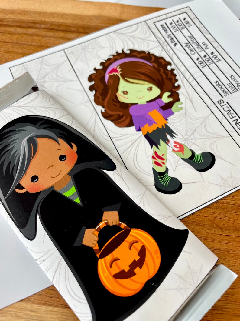 May include: A Halloween-themed chocolate bar wrapper featuring a cartoon witch with black hair and a black cape holding a jack-o'-lantern bucket. The wrapper also features a spiderweb pattern and the text "FN FACTS" with a list of percentages.