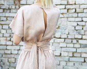 Linen dress with wide and long tie at the waist. Kneelength and short sleeve, V neckline. Summer dress with an open back.